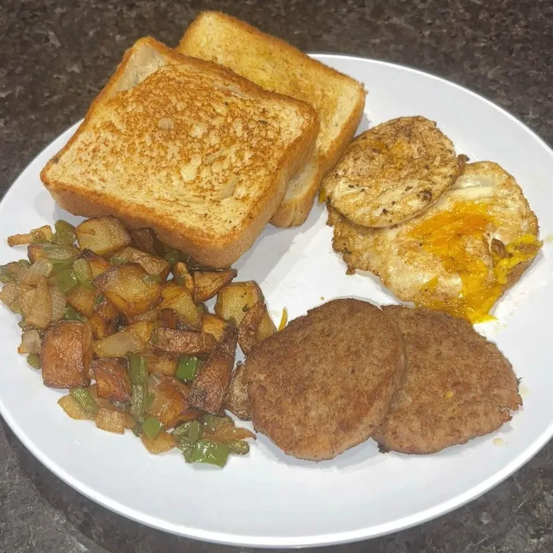 Early Bird breakfast with eggs, sausage patties, breakfast potatoes and toast